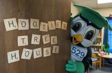 Hootie the Owl peeking behind a door in his Treehouse
