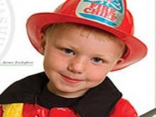Picture of Ayden as a child in fire fighter uniform